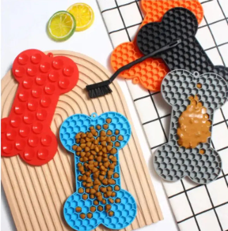 Bone-shaped lick mats with dog food and spread
